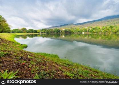 landscape lake views at Ang Kaew Chiang Mai University in nature forest Mountain views spring blue sky background with white cloud.