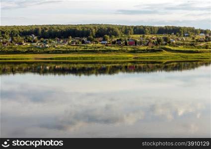landscape large lake on the edge of a village, russia, siberia