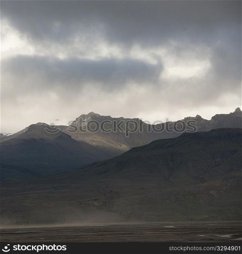 Landscape, mountain range under stormy skies