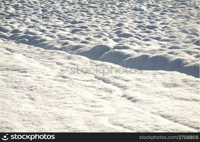 Landscape of a hill with a snow-covered track