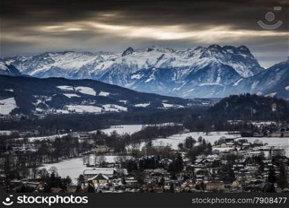 Landscape of high Alps near Salzburg covered by snow at cloudy day