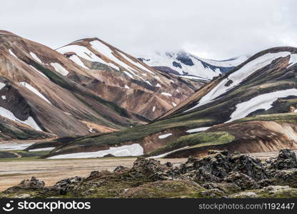 Landscape of Landmannalaugar surreal nature scenery in highland of Iceland, Nordic, Europe. Beautiful colorful snow mountain terrain famous for summer trekking adventure and outdoor walking.