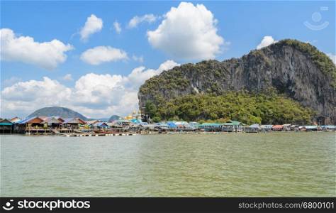 Landscape of limestone karsts of Phang Nga Bay National Park. Panyi island or Koh Panyee, floating fishing village in Phang Nga Province, Thailand