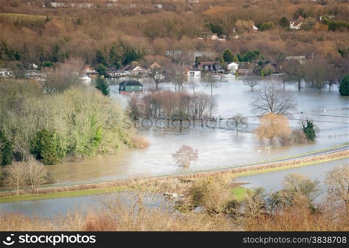 landscape of luxury homes and farmland under river floodwater