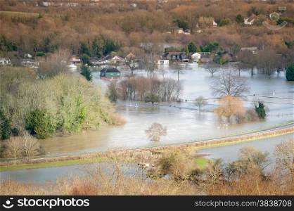landscape of luxury homes and farmland under river floodwater