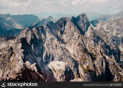 Landscape of mountain peaks, scenery from high summit on wide valley and rough mountain range in the Tatra Mountains