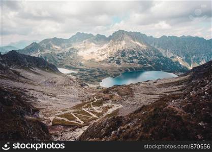Landscape of mountain peaks, scenery from high summit on wide valley and lakes