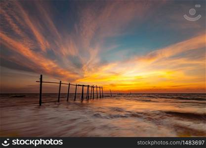 landscape of old wooden bridge with colorful sky in twilight time at Khok Kloi, Takua Thung District, Phang-nga, Thailand.