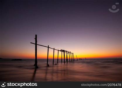 landscape of old wooden bridge with colorful sky in twilight time at Natai, Khok Kloi, Takua Thung District, Phang-nga, Thailand.
