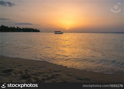 Landscape of paradise tropical island beach with boat background, sunset shot at Dominican republic ,Grand Bahia principe beach.