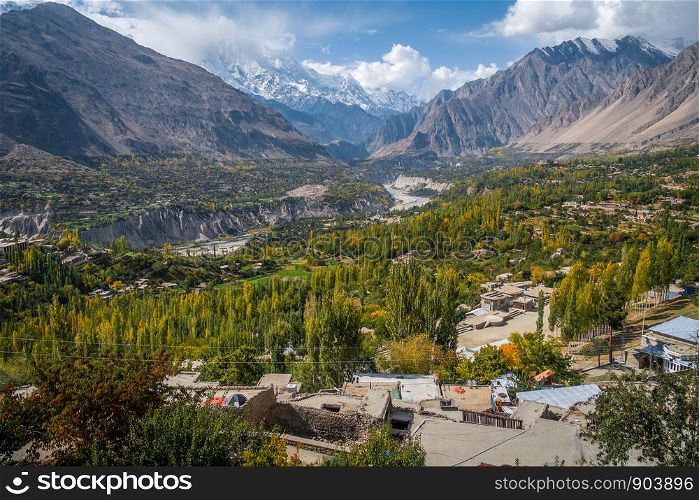 Landscape of peaceful Hunza Nagar valley in autumn with a view of snow capped Rakaposhi mountain in Karakoram range. Gilgit Baltistan, northern Pakistan.