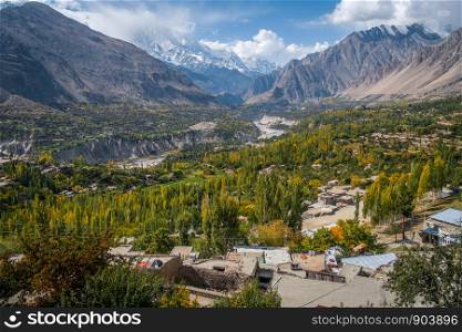Landscape of peaceful Hunza Nagar valley in autumn with a view of snow capped Rakaposhi mountain in Karakoram range. Gilgit Baltistan, northern Pakistan.