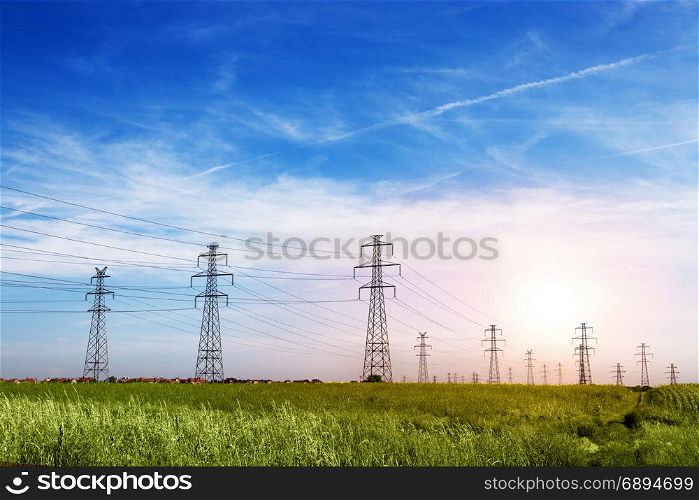Landscape of Power Line of the Electric Wires at the Blue Sky on the Green Grass