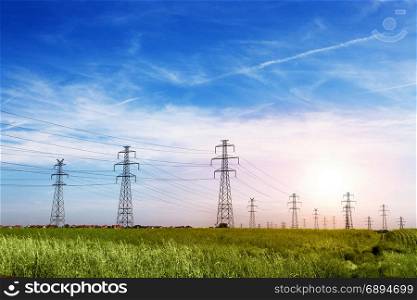 Landscape of Power Line of the Electric Wires at the Blue Sky on the Green Grass