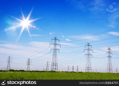 Landscape of Power Line of the Electric Wires at the Blue Sky with Bright Sun