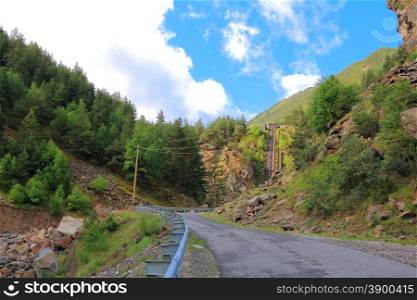 Landscape of road and lift in Caucasus green mountains