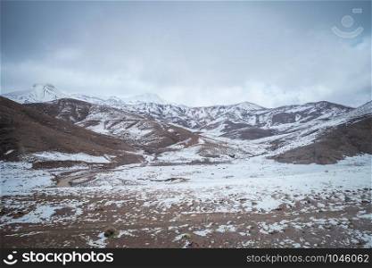 Landscape of snow capped mountains in the High Atlas range, Morocco.