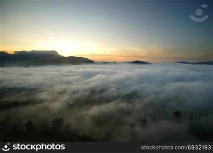 landscape of sunrise over the hills with sea fog