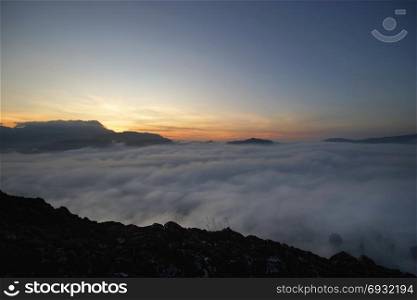 landscape of sunrise over the hills with sea fog