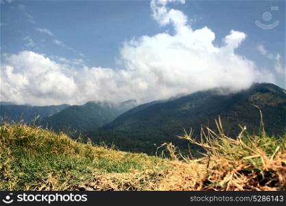 Landscape of the Caucasus mountains with clouds and grass