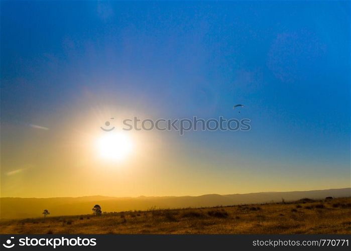 landscape of the eclipse in the mountains and paragliding in the sky