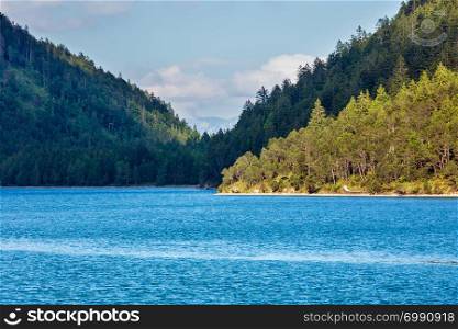 Landscape of the Lake Plansee with the shore covered with wood, Austria.