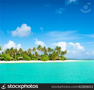 landscape of tropical island beach with palm trees and cloudy blue sky