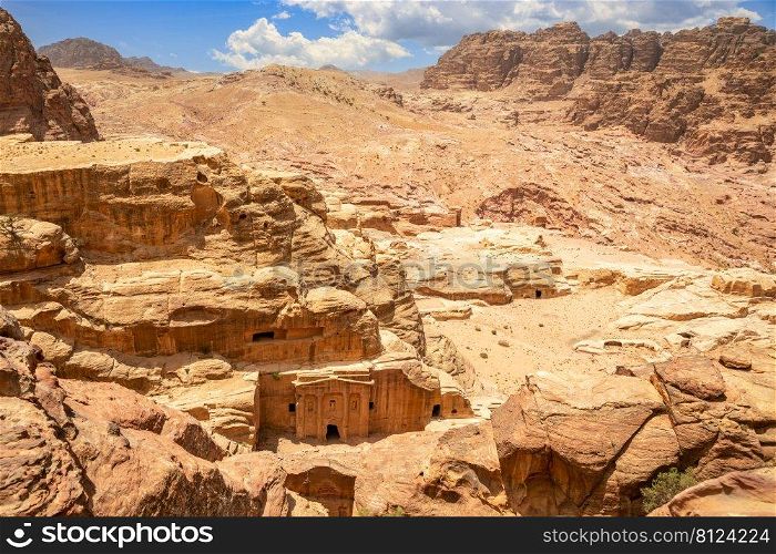 Landscape of Wadi Farasa canyon and view from above to the ancient tomb of Roman soldier and funeral ballroom carved in sandstone rock, Petra, Jordan
