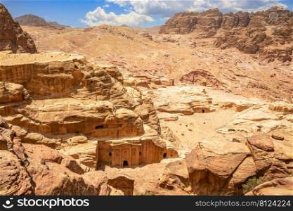 Landscape of Wadi Farasa canyon and view from above to the ancient tomb of Roman soldier and funeral ballroom carved in sandstone rock, Petra, Jordan