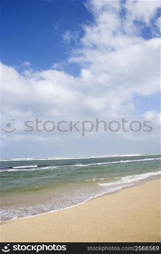 Landscape of waves lapping on beach.
