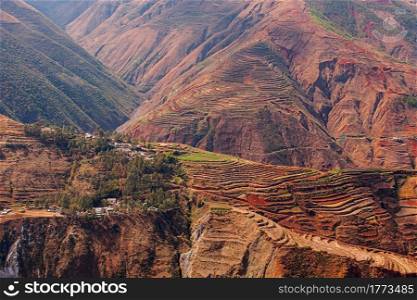 Landscape of wheat terraces and the loss of nutrient rich topsoil, rural scene in Yunnan, South China. Selective focus.
