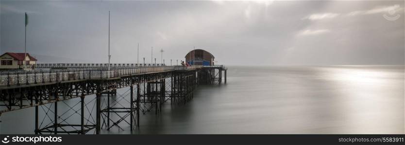 Landscape panorama long exposure moody image of Mumbles pier in Wales