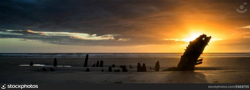 Landscape panorama shipwreck on Rhosilli Bay beach in Wales at sunset
