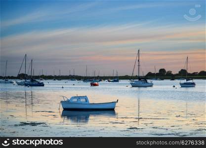 Landscape peaceful harbour at sunset with yachts in low tide