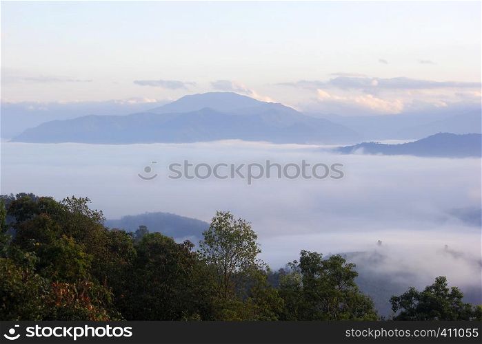 landscape photo of sea fog in the hills with beautiful sky background