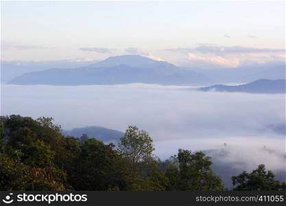 landscape photo of sea fog in the hills with beautiful sky background