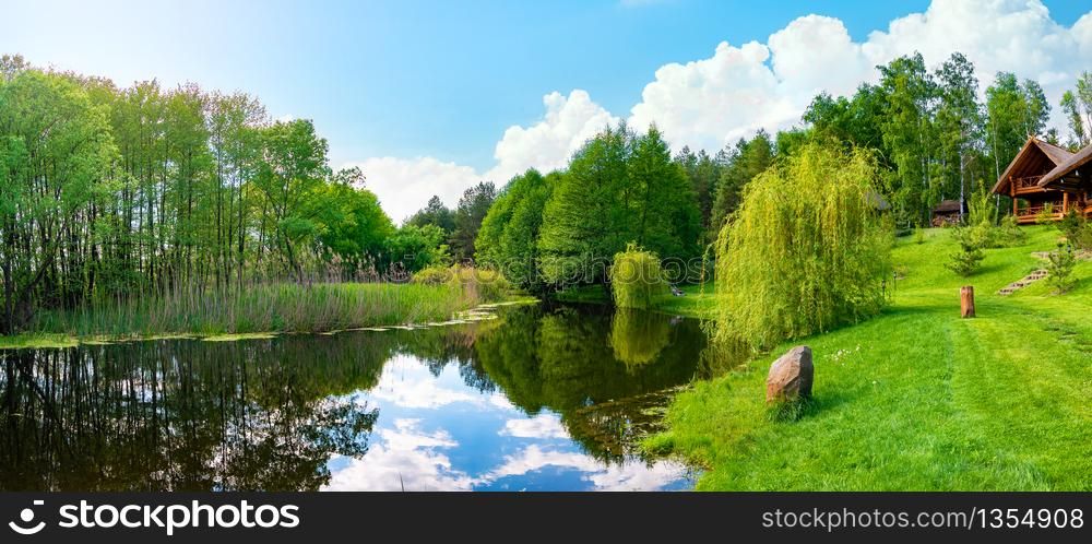Landscape pond and field in spring afternoon. Pond and field