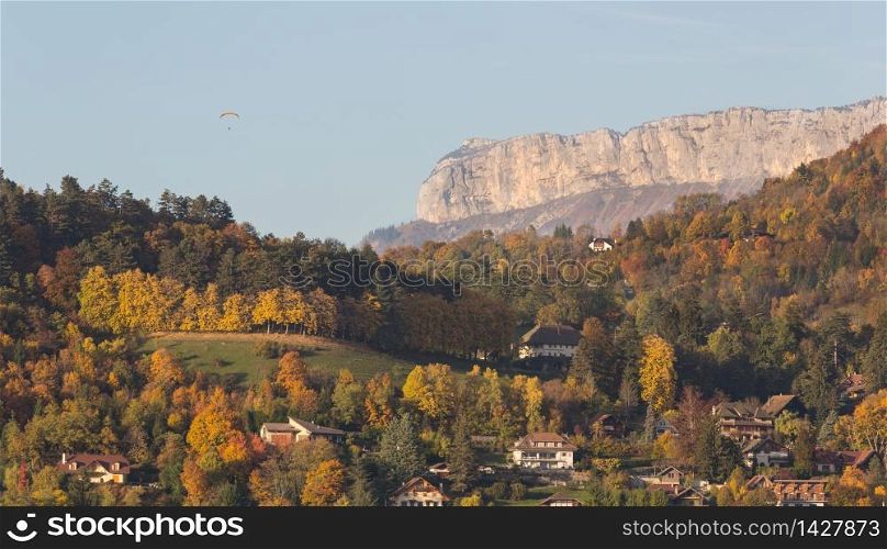 Landscape showing mountains with skydiver parachutist in the French Alps, Annecy
