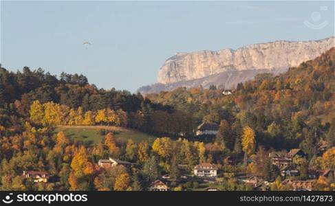 Landscape showing mountains with skydiver parachutist in the French Alps, Annecy