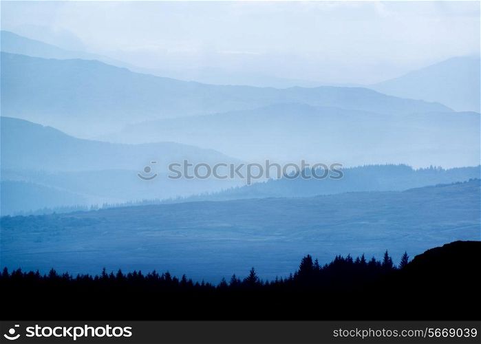 Landscape view from top of mountain on misty morning across countryside