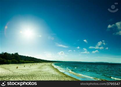 Landscape. View of blue cloudy sky at sea or ocean water with footprints at sandy beach. Resort.