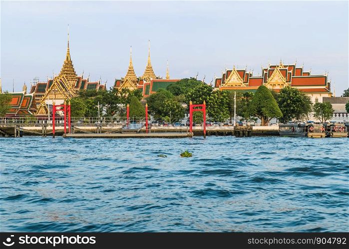 Landscape view of Chao Phraya River with Wat Phra Kaew and Grand Palace in the background. Bangkok, Thailand.
