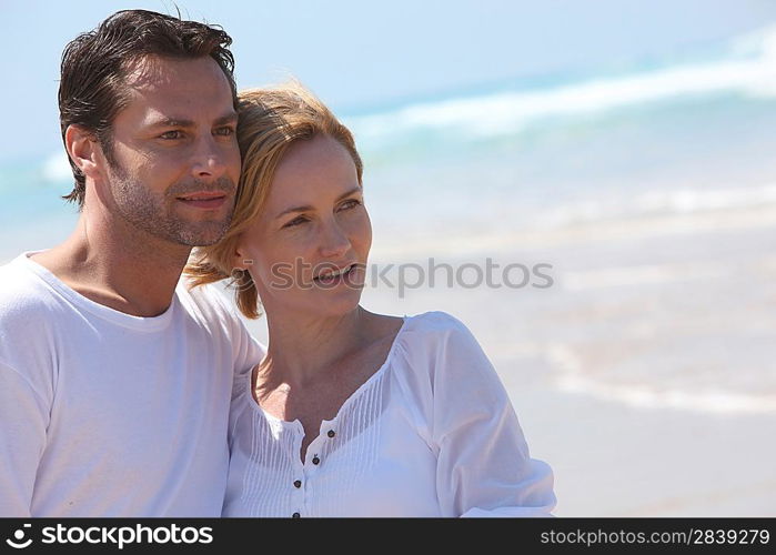 Landscape view of couple standing on a beach