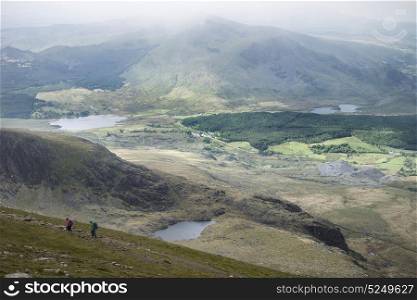 Landscape view of Llyn Cwellyn and Moel Cynghorion in Snowdonia shrouded in fog and low cloud