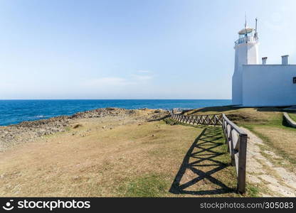 Landscape view of old white Inceburun lighthouse with blue sky on the north coast of Sinop,Turkey.. Landscape view of old white Inceburun lighthouse