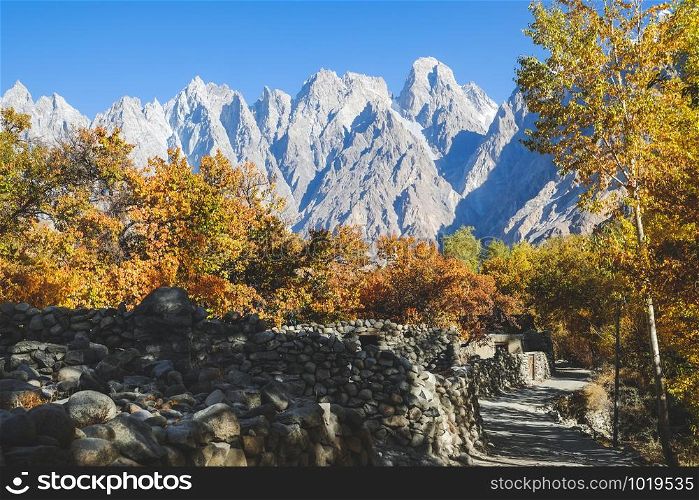Landscape view of Passu village in autumn with Passu cones in Karakoram mountain range in the background. Gojal valley, Gilgit Baltistan, Pakistan.
