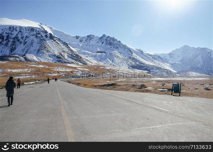 Landscape view of snow capped Karakoram mountain range along Karakoram highway paved road at Khunjerab Pass. Pakistan and China border, the highest-paved international border crossing in the world.