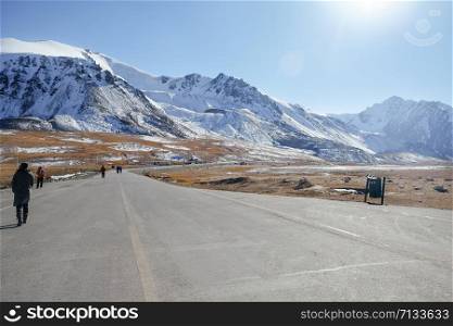 Landscape view of snow capped Karakoram mountain range along Karakoram highway paved road at Khunjerab Pass. Pakistan and China border, the highest-paved international border crossing in the world.