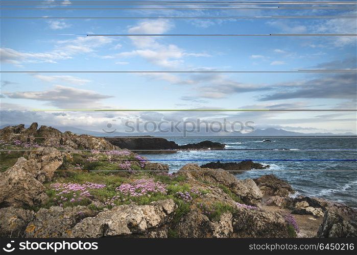 Landscape view of Snowdonia mountain range from Ynys Llanddwyn Island in Angelsey at sunset