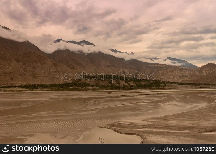 landscape view of the Indus river flowing through Katpana cold desert in Skardu, Gilgit Baltistan, Pakistan.
